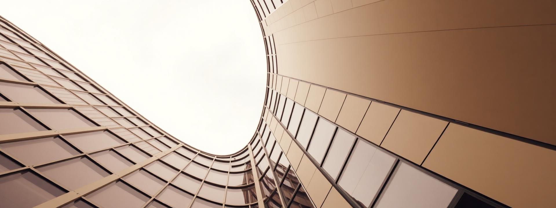 Looking up through a curved glass facade